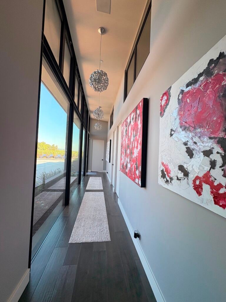 Spotless hallway with dark hardwood floors and floor-to-ceiling windows in a modern Napa home