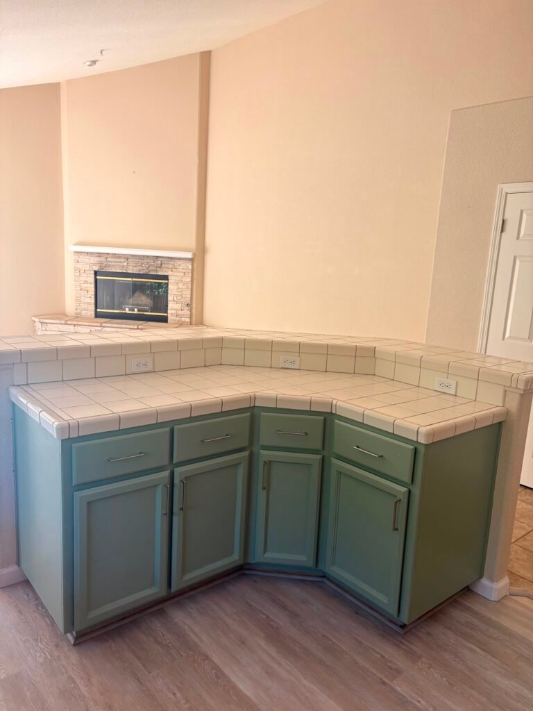 Cleaner wiping down a wine bottle display and mirror in a Napa Valley home