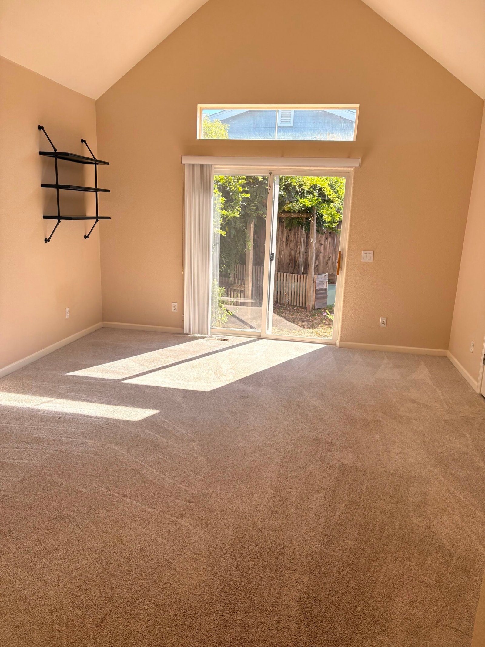 Freshly cleaned bedroom lounge area with round accent chair and made bed in a Napa home