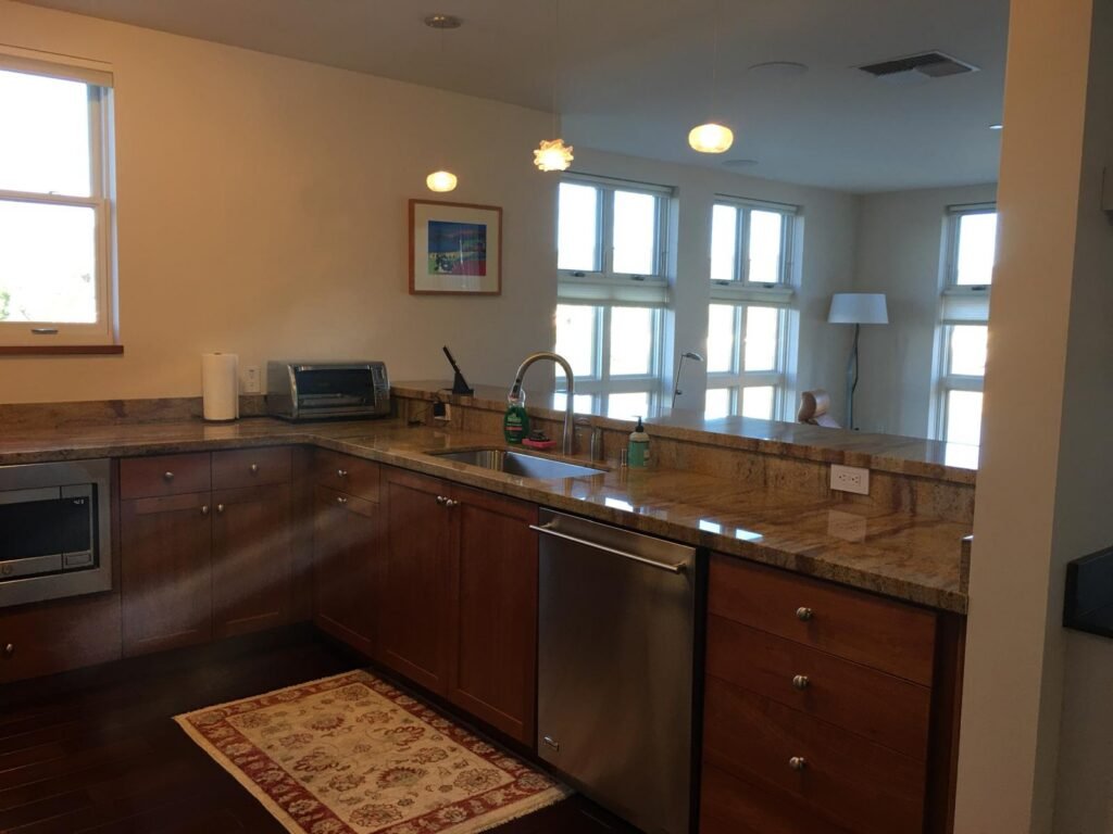 Bright living room with white brick fireplace and hardwood floors after a deep cleaning in Napa